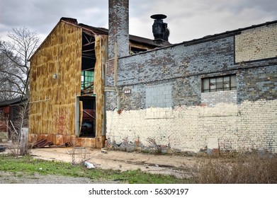 Image of exterior of abandoned warehouse with destroyed metal and brick walls. - Shutterstock ID 56309197