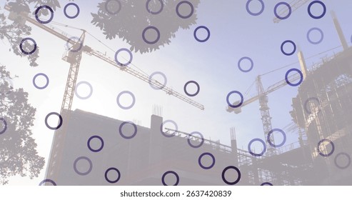Image of falling circles over construction site. Global connections, data processing and digital interface concept digitally generated image.