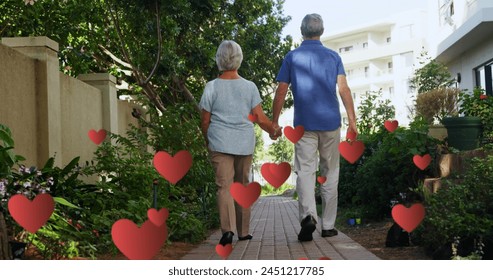 Image of falling hearts over caucasian senior couple walking. International day of older persons concept digitally generated image. - Powered by Shutterstock