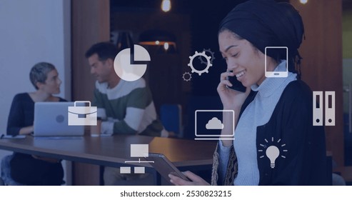 Image of falling icons over diverse group of business people. global business, finances, data processing and digital interface concept digitally generated image.