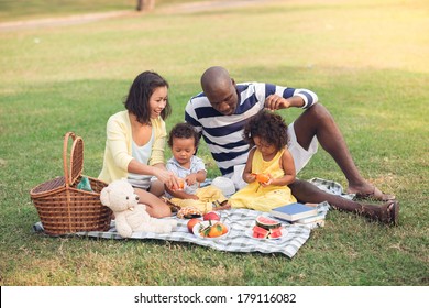 Image of a family having picnic outdoors - Powered by Shutterstock