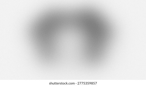 The image features an abstract blurred texture with subtle patterns. The central area is darker and gradually fades into a lighter background. The overall effect is a soft, diffused appearance with minimal distinguishable details. The image is monochromatic, primarily in shades of gray, and has a smooth, even tone. The lack of sharp edges and fine details gives it a calming and serene ambiance.