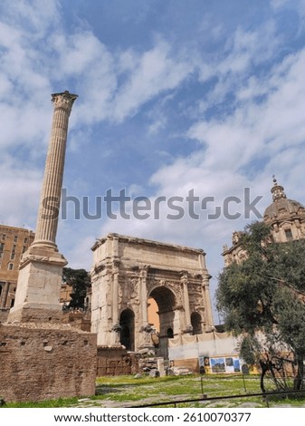 The image features the Arch of Septimius Severus and a nearby column in the Roman Forum. The scene is bathed in sunlight with a mix of ancient stone ruins and historical architecture, creating a pictu