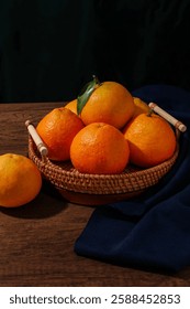 The image features a basket filled with various types of oranges, showcasing their vibrant colors and textures. The scene highlights the natural appeal of these fruits, 
