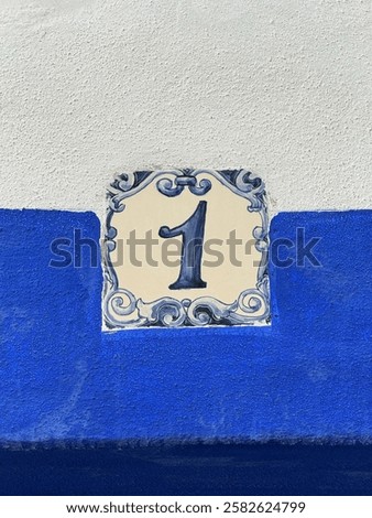 The image features a beautifully designed ceramic house number tile with the number 