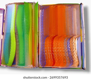 The image features a box of combs in various colors. It is an indoor setting that highlights the beauty and functionality of hair combs.
