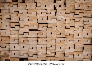 The image features a close-up view of a stack of wooden beams with a unique interlocking pattern.