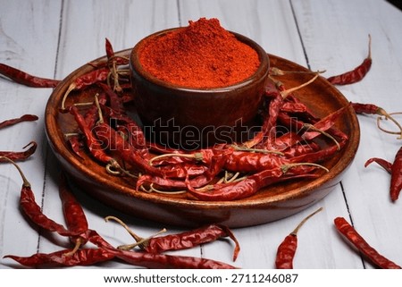 The image features dried red chilies and red chili powder, a fundamental spice in many cuisines. 
