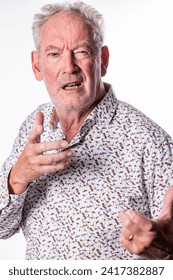 The image features an elderly man mid-conversation, his face animated with expression. He appears to be speaking passionately, with one hand raised and his mouth open as if emphasizing a point. His