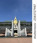 The image features the Thai Parliament building, an architectural masterpiece combining modern design with traditional Thai elements. The golden spire atop the structure symbolizes Thai heritage, whil