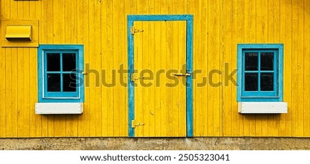 The image features a vibrant yellow wall with a blue-framed door and two blue-framed windows with white sills. The door has three hinges and a latch, while the wall includes a small yellow vent on the