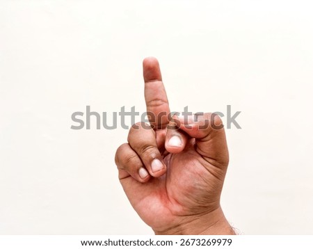 Image featuring a hand making an offensive gesture by pointing up the middle finger, a common symbol of insult, defiance, and disrespect isolated on a clean white backdrop.