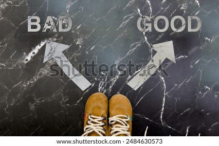 Image of feet standing at a crossroad with arrows pointing to 'Good' and 'Bad' choices symbolizing decision making.