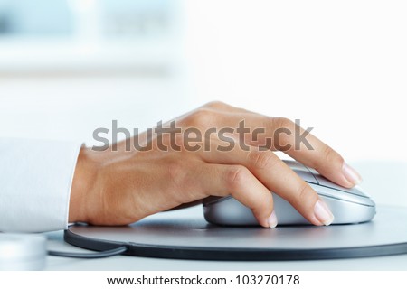 Image of female hand clicking computer mouse