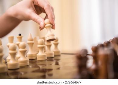 Image Of Female Hand Is Playing Chess.