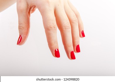 An image of female hand with red painted nails