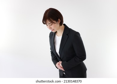 Image of a female office worker bowing 
