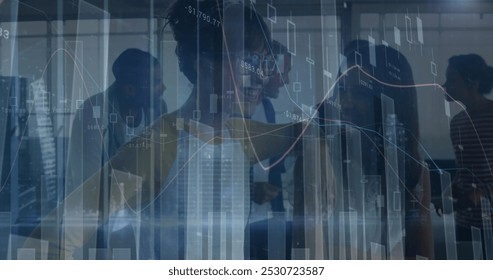 Image of financial data and graphs over diverse businesspeople in office. Finance, economy and business concept digitally generated image.