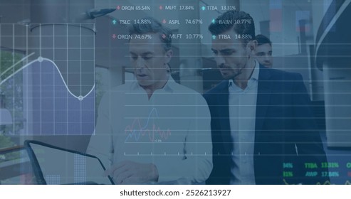 Image of financial data processing against two diverse businessmen discussing at office. Global economy and business data technology concept
