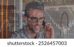 Image of financial data processing over biracial man talking on smartphone against tall building. Global economy and business technology concept