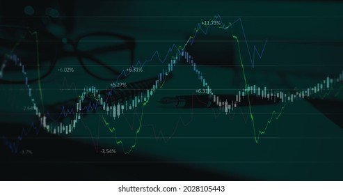 Image of financial data processing over pen, notebook and glasses. global business and finances concept digitally generated image.