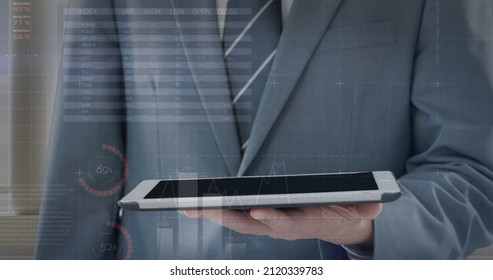 Image of financial data processing over businessman using tablet. global business, finances, digital interface and connections concept digitally generated image.