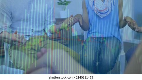 Image of financial data processing over diverse people holding hands. global finance, business and digital interface concept digitally generated image.