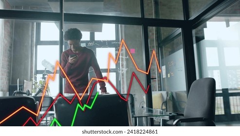 Image of financial data processing over african american businessman using smartphone. Global finance, business, connections, computing and data processing concept digitally generated image.