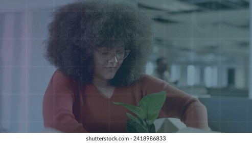 Image of financial data processing over african american businesswoman in office. Global finance, business, connections, computing and data processing concept digitally generated image.