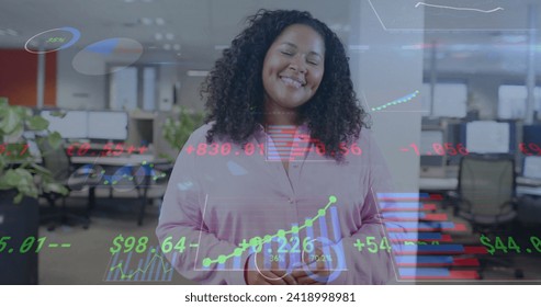 Image of financial data processing over smiling biracial businesswoman in office. Global finance, business, connections, computing and data processing concept digitally generated image.