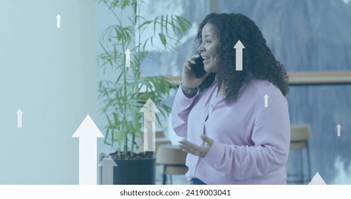 Image of financial data processing over biracial businesswoman in office. Global finance, business, connections, computing and data processing concept digitally generated image.
