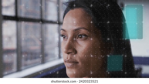 Image of financial data processing over biracial businesswoman in office. Global business, finances, computing and data processing concept digitally generated image.