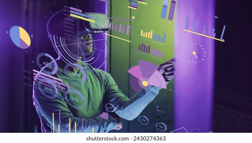 Image of financial data processing over african american businessman using vr headset. Global business, finances, computing and data processing concept digitally generated image.