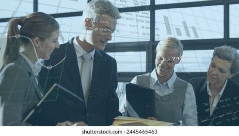 Image of financial data processing over diverse business people in office. Global business, finances, computing and data processing concept digitally generated image.