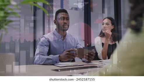 Image of financial data processing over diverse business people at office. Global finances, business and digital interface concept digitally generated image.
