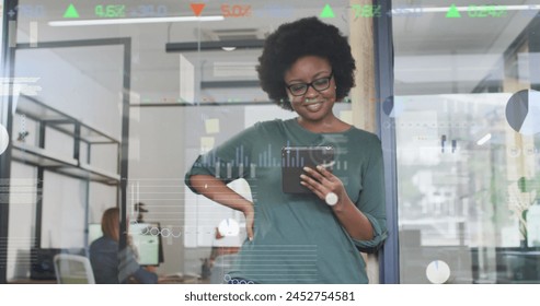 Image of financial data processing over african american businesswoman. global business, technology and digital interface concept digitally generated image.
