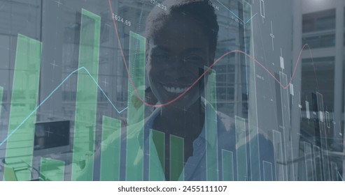 Image of financial data processing over happy african american businesswoman. business, digital interface and data processing concept digitally generated image.