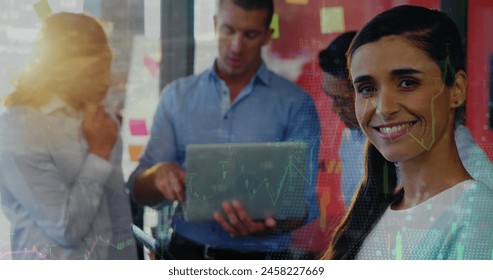 Image of financial data processing over diverse business people using electronic devices. Global business, finance, computing and data processing concept digitally generated image.