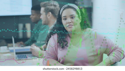 Image of financial data processing over diverse business people in office. Global business, finance, computing and data processing concept digitally generated image.