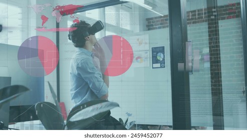 Image of financial data processing over biracial businessman wearing vr headset in office. Global business, finances, computing and data processing concept digitally generated image.