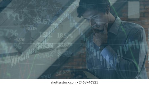 Image of financial data processing over caucasian businessman using tablet. Global business, finance, computing and data processing concept digitally generated image.