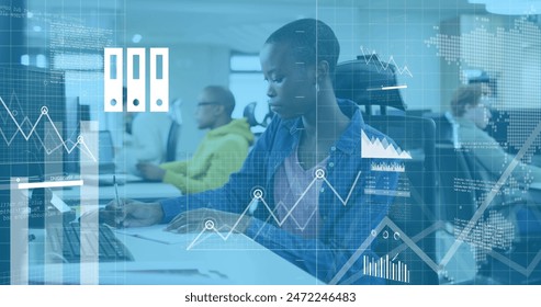 Image of financial data processing over african american businesswoman in office. Global business, finances, computing and data processing concept digitally generated image.