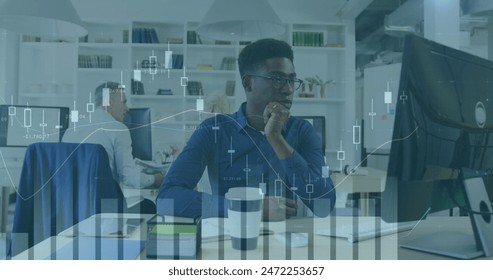 Image of financial data processing over afrcian american businessman in office. Global computing, digital interface and data processing concept digitally generated image.