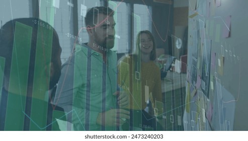 Image of financial data processing over diverse business people in office. Global business, finance, computing and data processing concept digitally generated image.