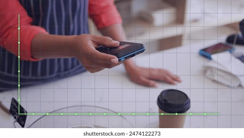 Image of financial data processing over man paying with smartphone. Global online payment, business, finance, computing and data processing concept digitally generated image.