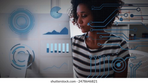 Image of financial data processing over biracial businesswoman using laptop. Global computing, digital interface and data processing concept digitally generated image.