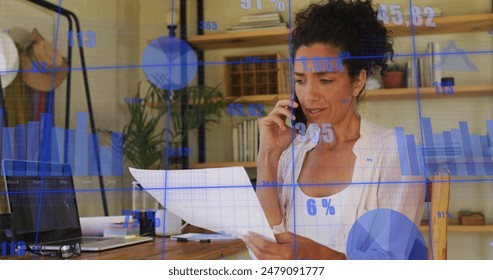 Image of financial data processing over biracial businesswoman using smartphone in office. Global business, finance, computing and data processing concept digitally generated image.