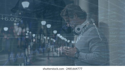 Image of financial data processing over happy caucasian man using smartphone on the street. Computer interface and business data technology concept