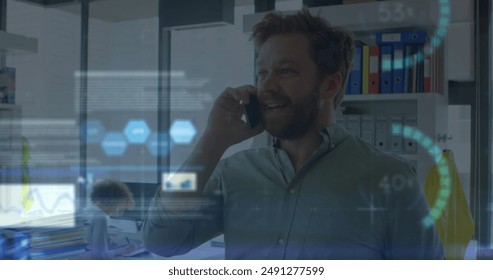 Image of financial data processing over man using smartphone. Global business, finances, computing and data processing concept digitally generated image.