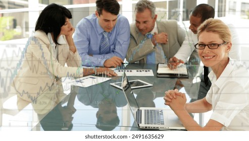 Image of financial data processing over diverse business people. Global business, finances, computing and data processing concept digitally generated image.